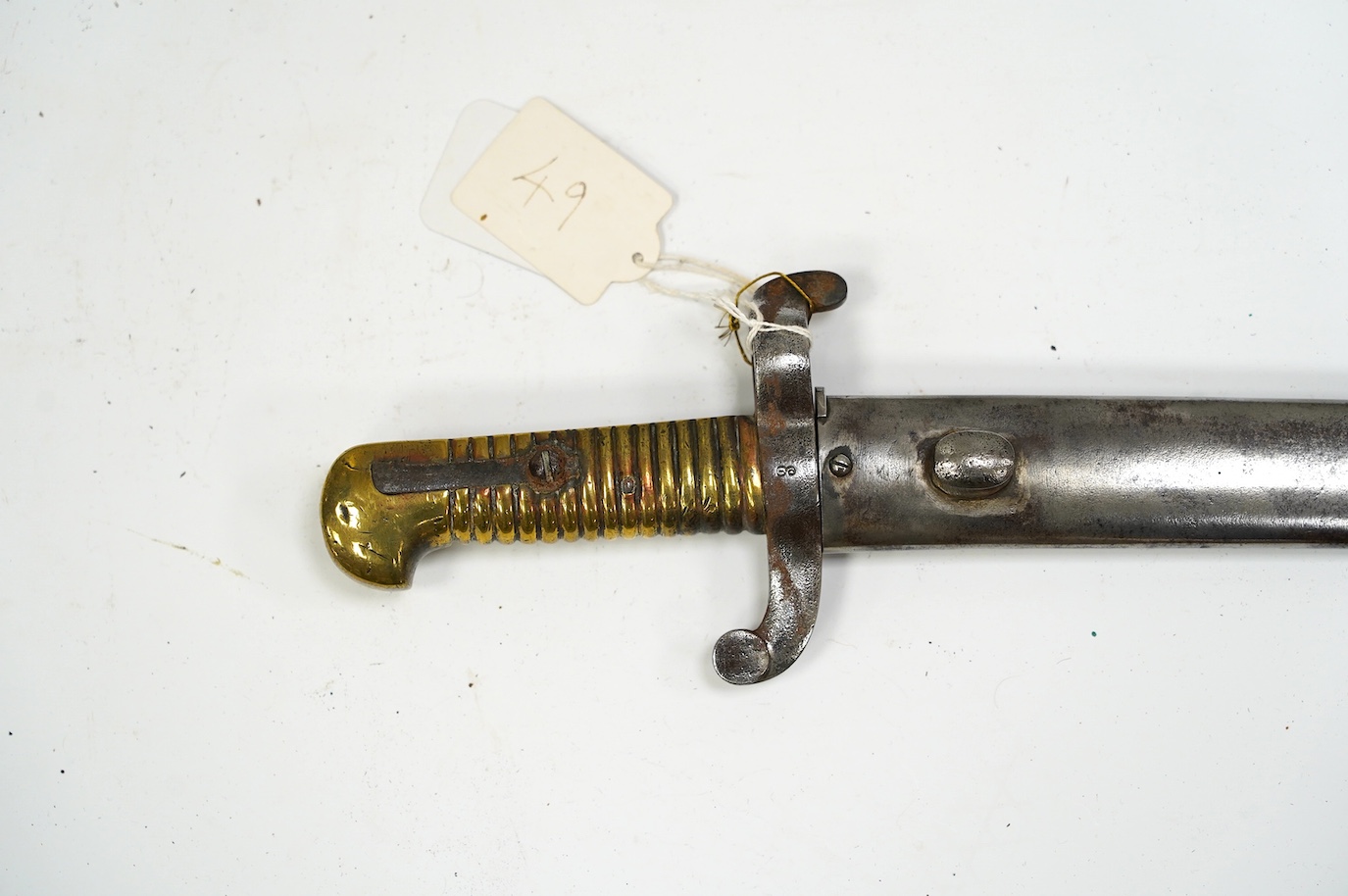 An 1855 French bayonet in its scabbard. Condition - good